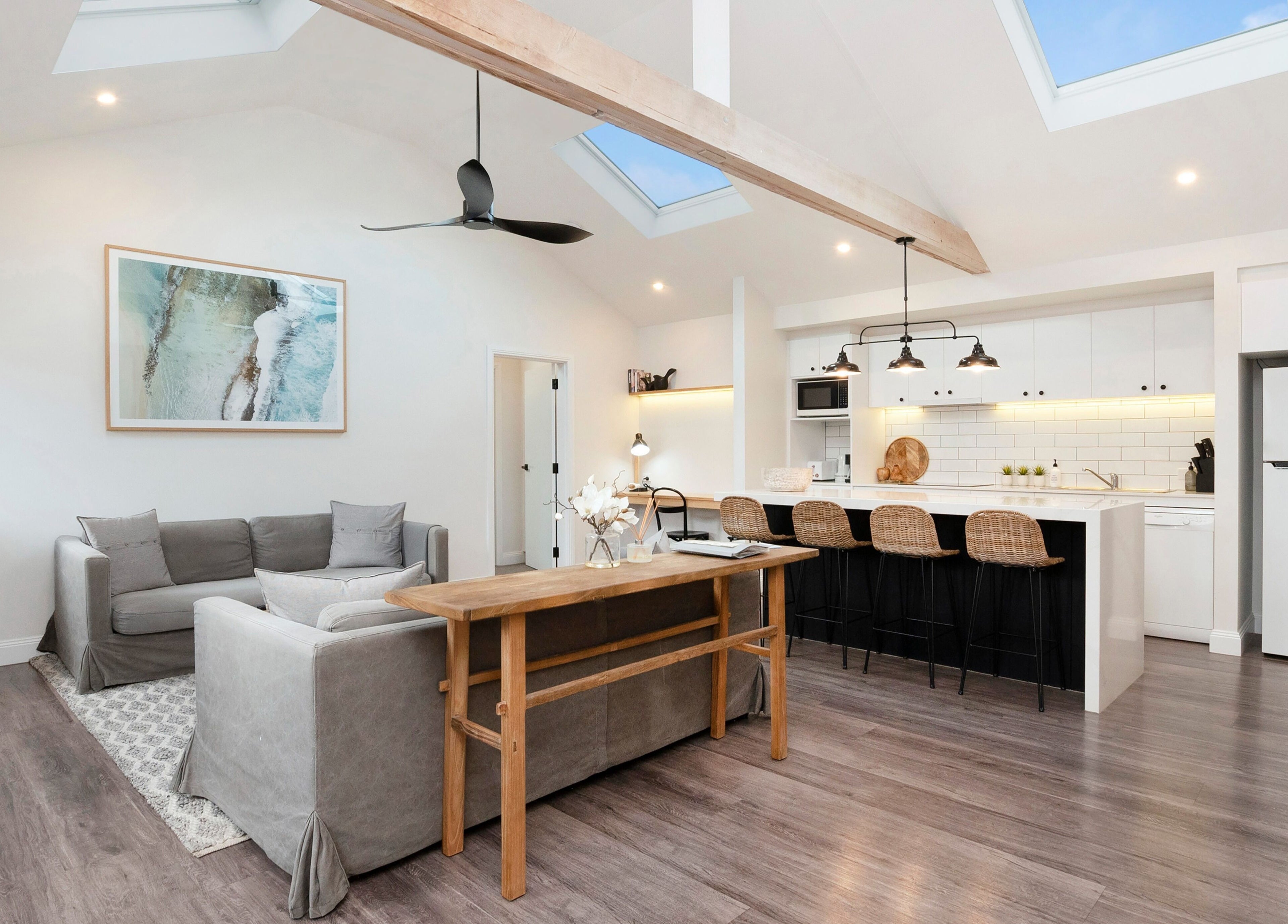 Spacious lounge and kitchen area at Port Fairy Day Spa, Port Fairy, Victoria, AU, featuring modern decor.