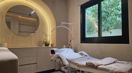 Relaxing treatment room at Serenity Secret Beauty Salon and Spa, Dubai, AE with a cozy massage bed and vibrant greenery.