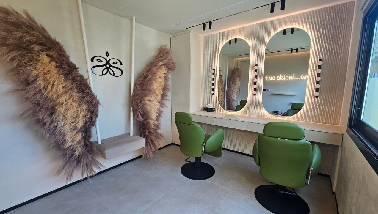 Cozy salon space with green chairs and decor at Serenity Secret Beauty Salon and Spa in Dubai, AE.
