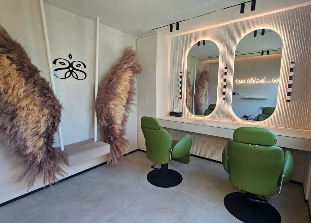 Cozy salon space with green chairs and decor at Serenity Secret Beauty Salon and Spa in Dubai, AE.