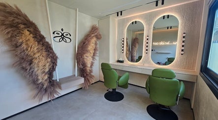 Cozy salon space with green chairs and decor at Serenity Secret Beauty Salon and Spa in Dubai, AE.