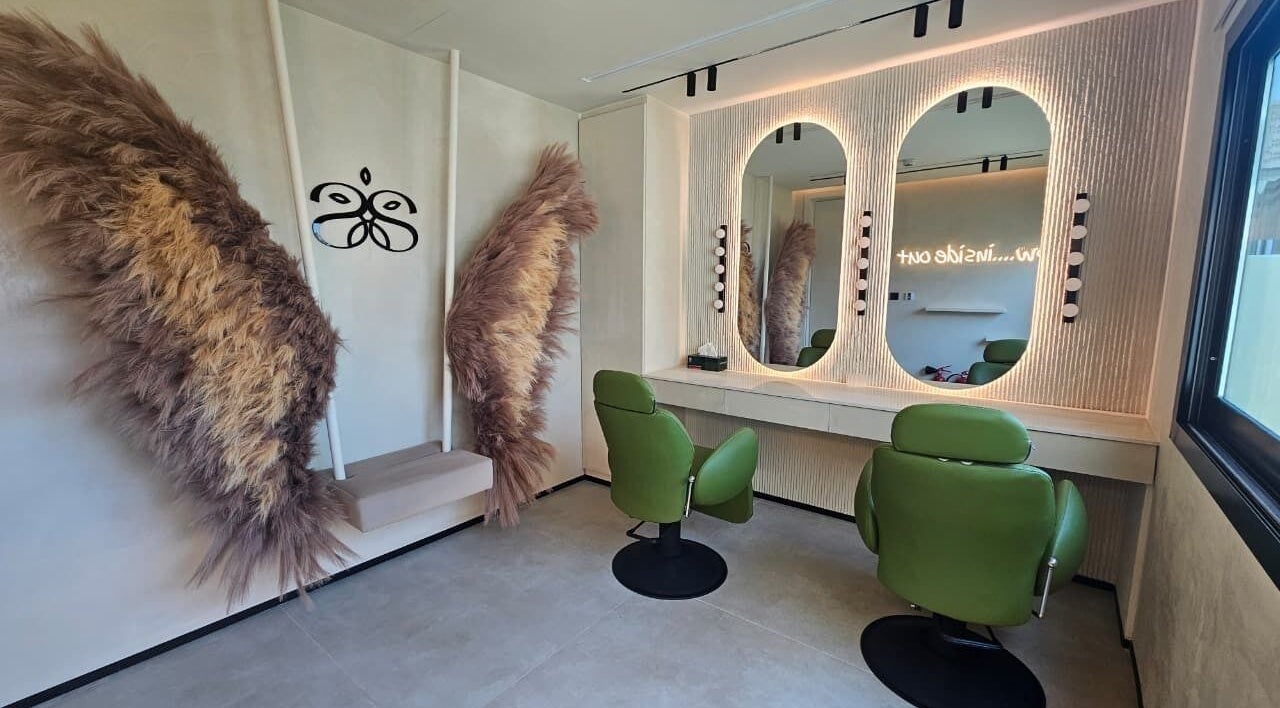 Cozy salon space with green chairs and decor at Serenity Secret Beauty Salon and Spa in Dubai, AE.