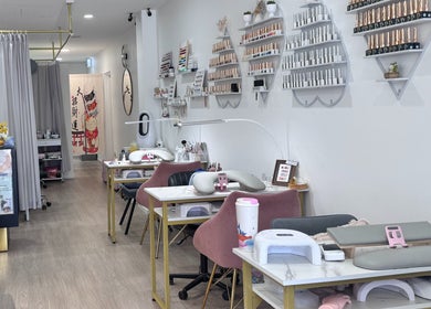 Interior view of Luna Nails & Beauty, Southport, Queensland, AU, featuring elegant manicure stations and nail polish displays.