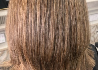 Elegant layered haircut at Hairbylianne in Leeds, England, GB showcasing smooth, sleek finish.