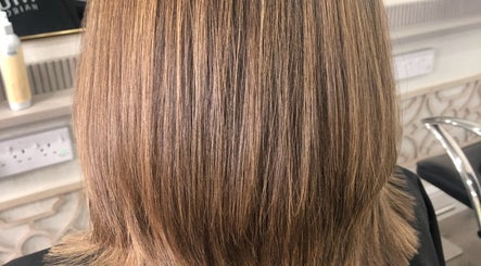 Elegant layered haircut at Hairbylianne in Leeds, England, GB showcasing smooth, sleek finish.