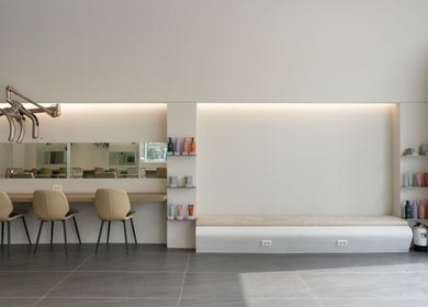 Modern interior of weneedblack forenadangsan salon with beige chairs and elegant decor, located in 서울특별시, 서울특별시, KR.