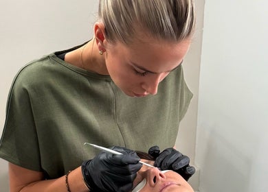 Beauty professional performing eyelash treatment at Soluna, Par, England, GB. Precision care and relaxation.