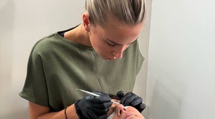 Beauty professional performing eyelash treatment at Soluna, Par, England, GB. Precision care and relaxation.