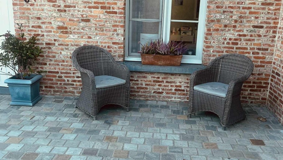 Gezellig terras met rieten stoelen bij Schoonheidsinstituut Amaris in Izegem, Vlaanderen, BE.