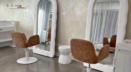 Modern salon interior at Aloha Hair & co, Varsity Lakes, Queensland, AU showcasing stylish chairs and large mirrors.