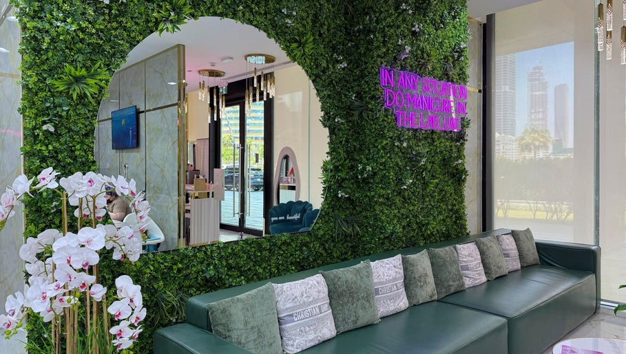 Elegant interior of Adelya Al Medina Beauty Salon in Dubai, AE. Features lush greenery and ambient decor.