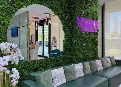 Elegant interior of Adelya Al Medina Beauty Salon in Dubai, AE. Features lush greenery and ambient decor.