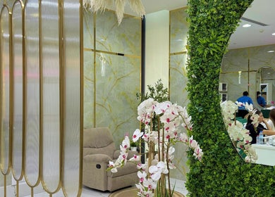 Luxurious interior of Adelya Al Medina Beauty Salon, Dubai, AE with floral decor and comfortable seating.