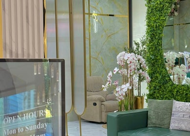 Elegant lounge at Adelya Al Medina Beauty Salon, Dubai, AE with plush seating and floral decor.