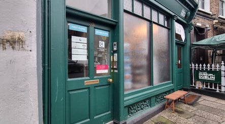Entrance of The Peak Wellness Studio in Dublin, County Dublin, IE featuring a green door and glass panels.