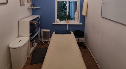 Cozy massage room at The Peak Wellness Studio, Dublin, County Dublin, IE, with soothing blue and white decor.