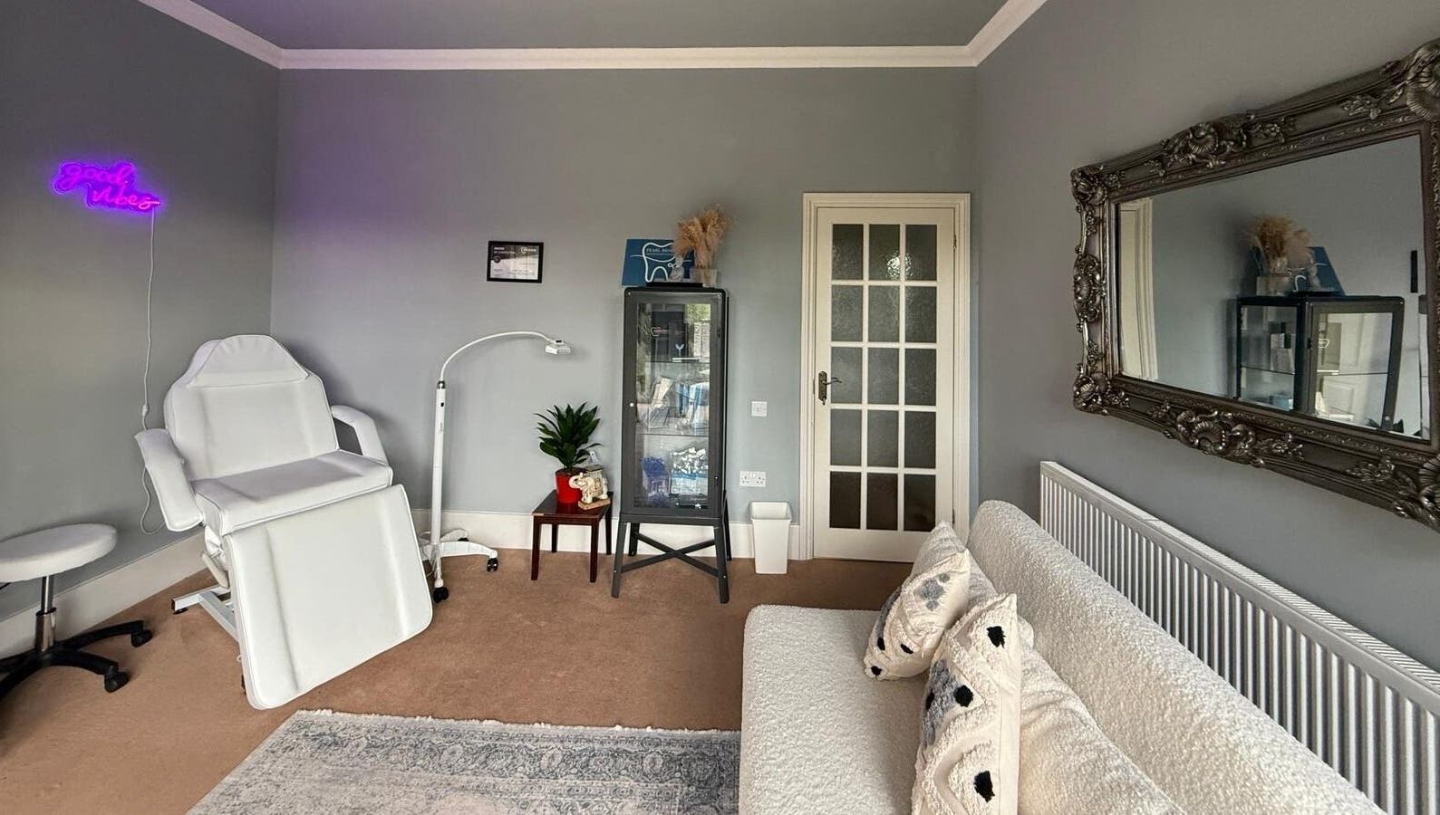 Relaxing treatment room at Pearl Brite, Newport, Wales, GB, featuring a plush chair and elegant decor.