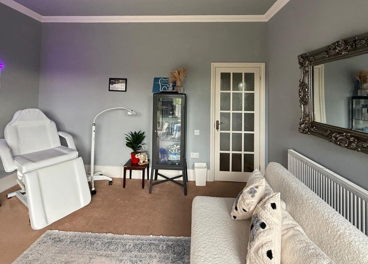 Relaxing treatment room at Pearl Brite, Newport, Wales, GB, featuring a plush chair and elegant decor.
