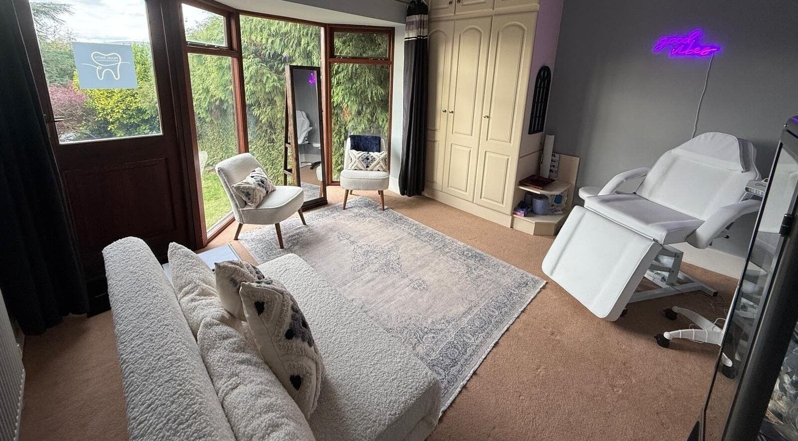 Cozy beauty room in Pearl Brite, Newport, Wales, GB with comfy chairs, soft lighting, and elegant decor.