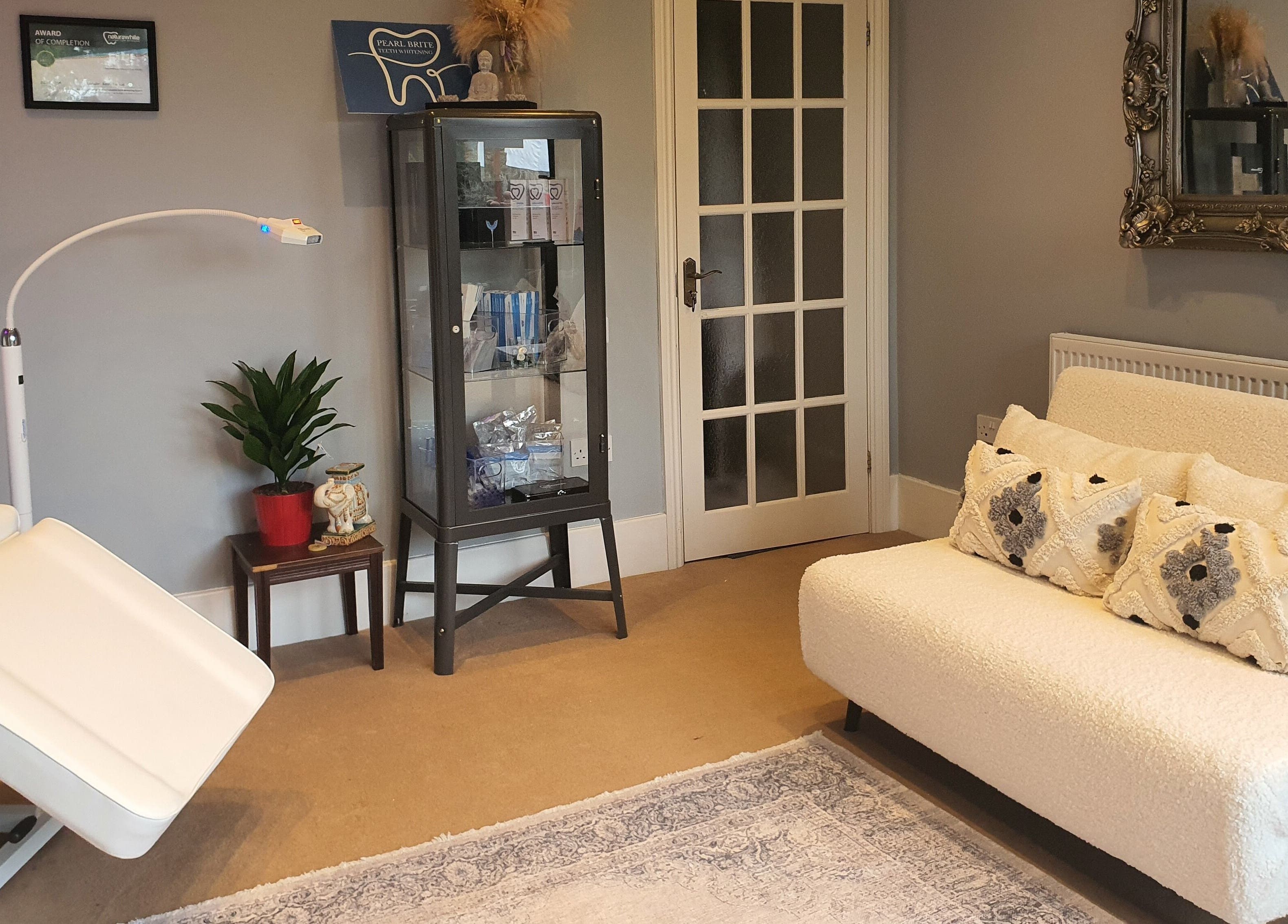 Cozy therapy room at Pearl Brite, Newport, Wales, GB with elegant decor and comfortable seating.