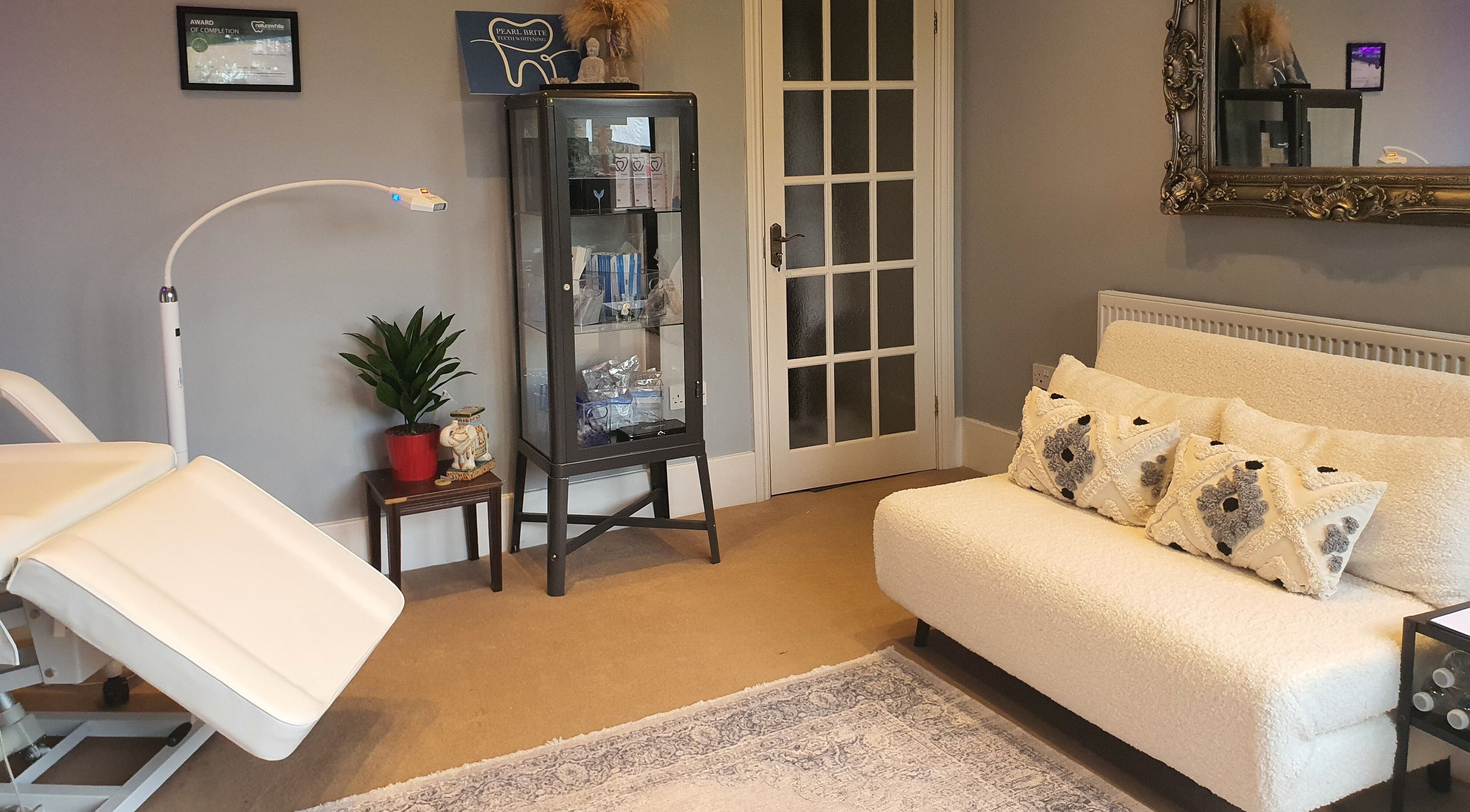 Cozy therapy room at Pearl Brite, Newport, Wales, GB with elegant decor and comfortable seating.