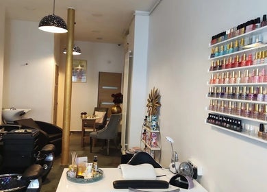 Salon de manucure élégant chez Gold Empire Spa, Paris, Île-de-France, FR, avec vernis colorés alignés.