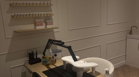 Modern nail station at Refined By Courtney Joyce in Hucclecote, England, GB featuring chic decor and nail polish display.
