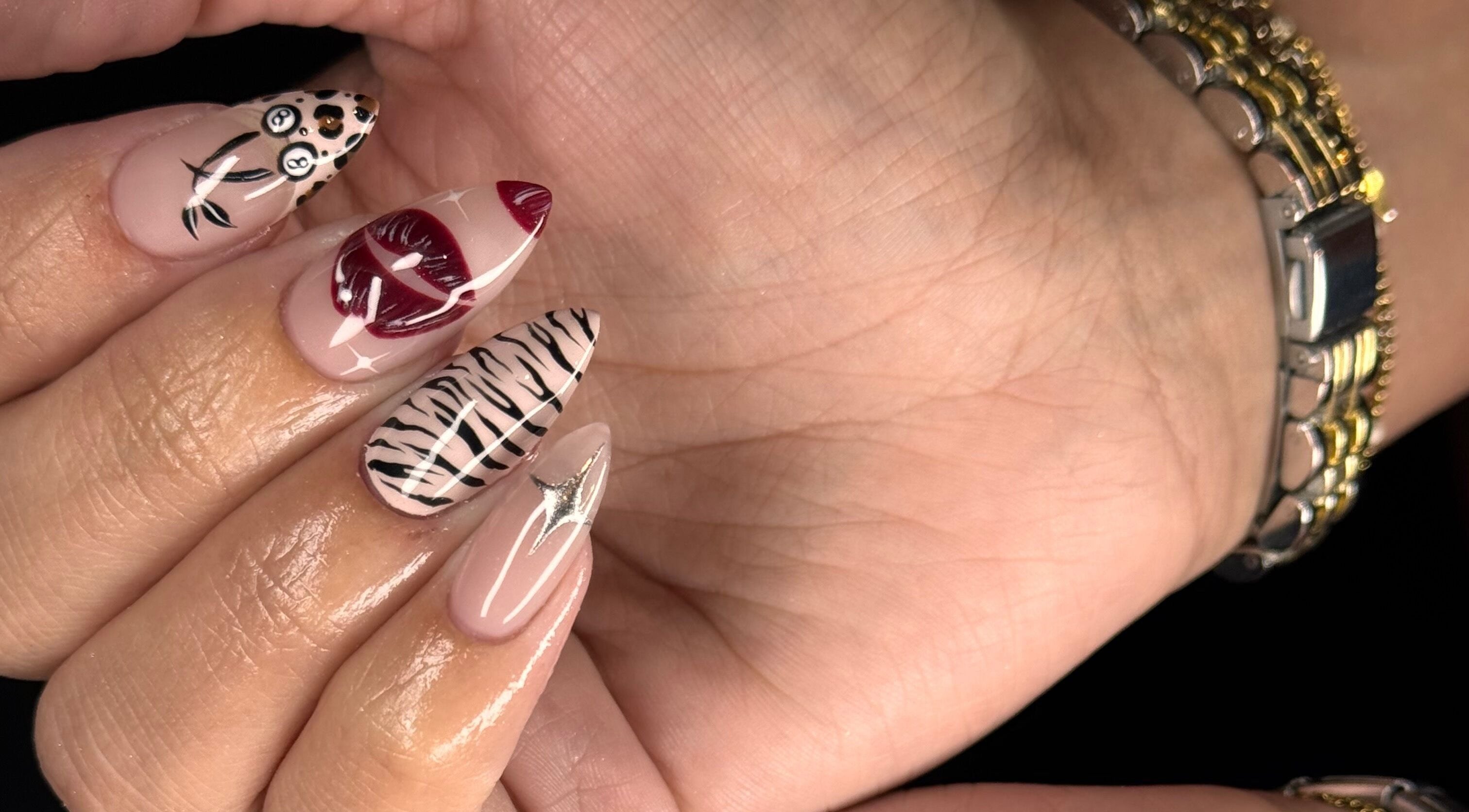 Artistic nail designs at Refined By Courtney Joyce, Hucclecote, England, GB, featuring intricate patterns.