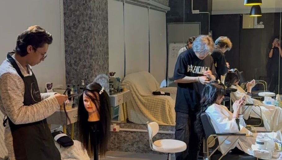 Stylists at Marone Private Hair Extension and Hair Studio, Kuala Lumpur, attending to clients in a modern setting.