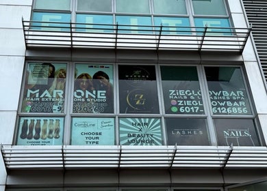 Front view of Marone Private Hair Extension and Hair Studio in Kuala Lumpur, showcasing professional signage and glass façade.