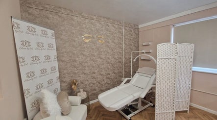 Relaxing treatment room at Beautybyrumaysa, Stoke-on-Trent, England, GB with a comfy chair and bed.