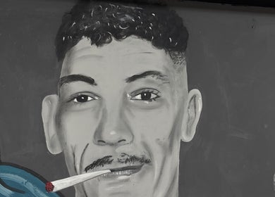 Artistic mural at Ussy’s Barbers, Thornaby, England, GB showcases a striking portrait.