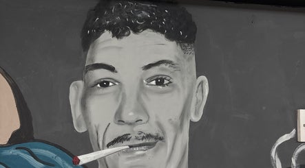 Artistic mural at Ussy’s Barbers, Thornaby, England, GB showcases a striking portrait.