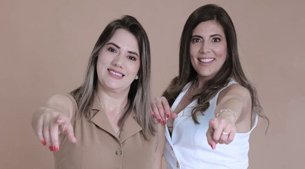Two smiling women pointing at Harmony Aesthetic & Spa, Goose Creek, South Carolina, US.