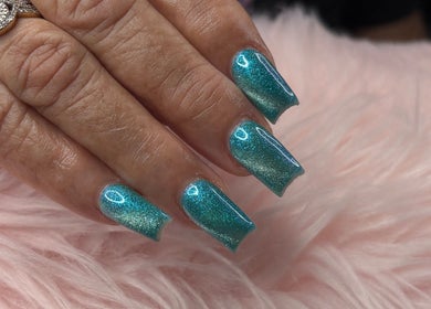 Glistening aqua nails at The Look Nails By Taria, Marsh Harbour, Central Abaco, BS, shimmering on a soft pink fur.