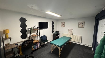 A&M Physiotherapy's serene therapy room in Kenilworth, England, GB featuring a treatment table and decor.
