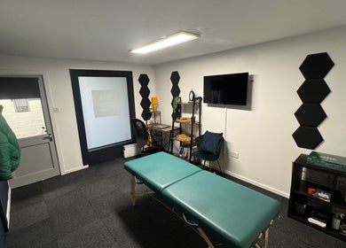 A&M Physiotherapy in Kenilworth, England, GB offers a peaceful treatment room with a massage table and modern decor.