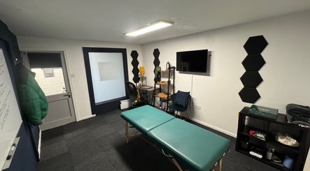 A&M Physiotherapy in Kenilworth, England, GB offers a peaceful treatment room with a massage table and modern decor.