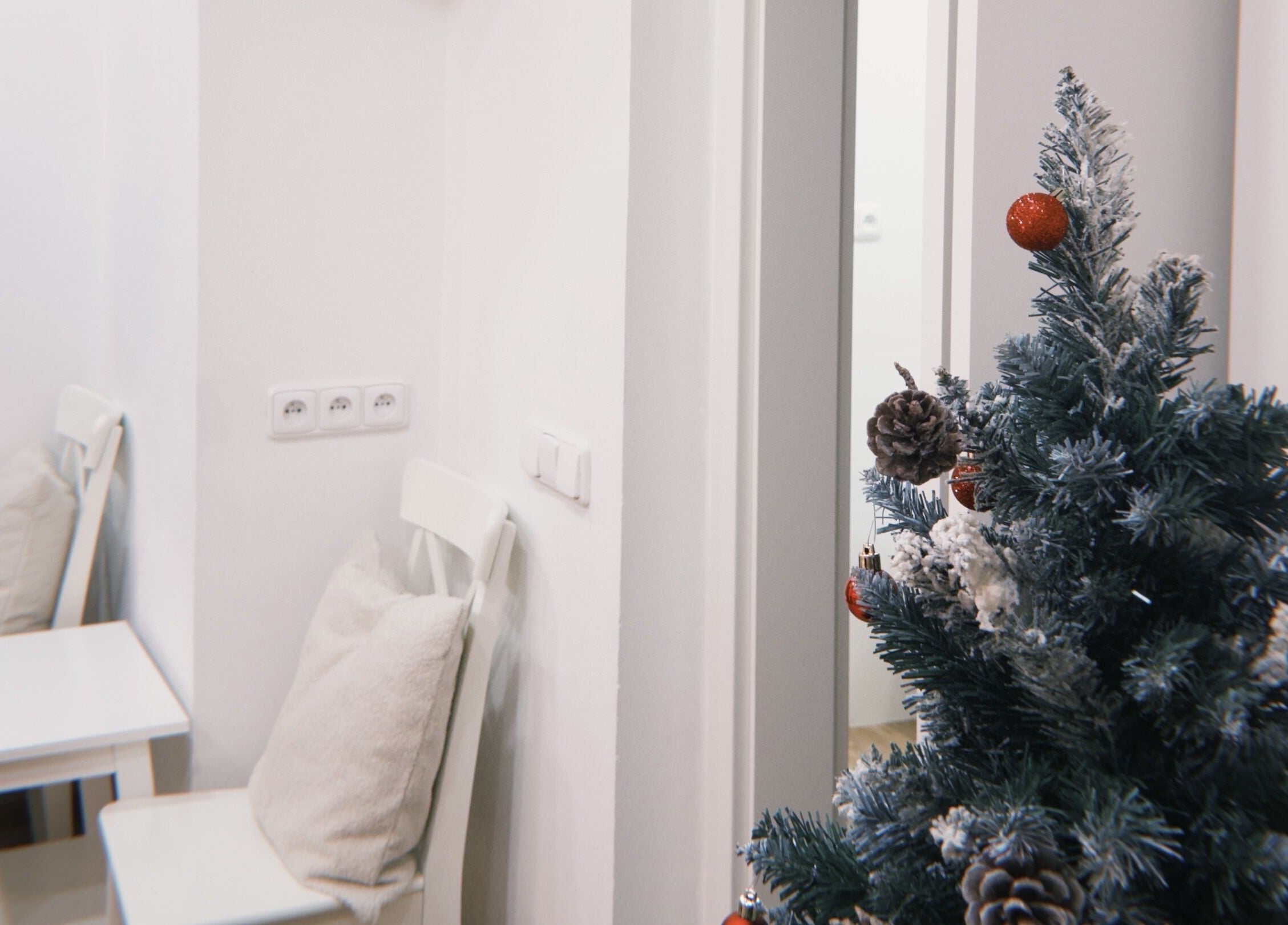 Cozy holiday decor at Bali & Sport Massage, Hlavní Město Praha, CZ, featuring a pinecone adorned tree.
