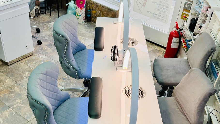 Chic nail stations at American Nail Design, London, England, GB, featuring luxurious chairs and modern decor.