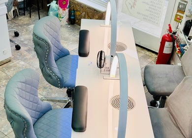 Chic nail stations at American Nail Design, London, England, GB, featuring luxurious chairs and modern decor.