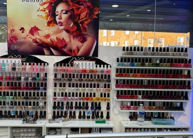Colorful nail polishes displayed at American Nail Design, London, England, GB, enhancing beauty and wellness.