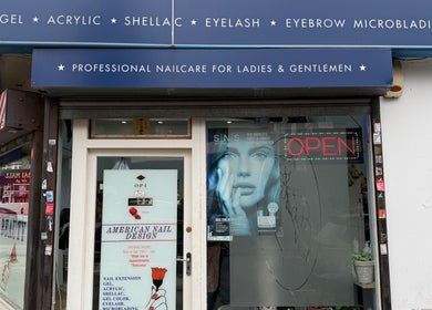 Front view of American Nail Design in London, England, GB, showcasing nail services signage.