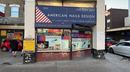 Exterior of American Nail Design in London, England, GB, showcasing vibrant signage and storefront.