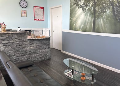 Inviting lobby of Massage Randolph, Colesville, Maryland, US featuring cozy seating and nature wall art.