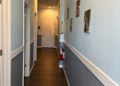 Tranquil hallway at Massage Randolph in Colesville, Maryland, US, featuring calming decor and wooden flooring.