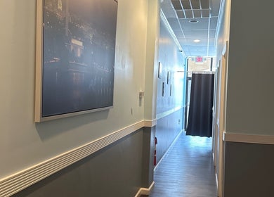 Bright hallway at Massage Randolph in Colesville, Maryland, US leading to serene treatment rooms.