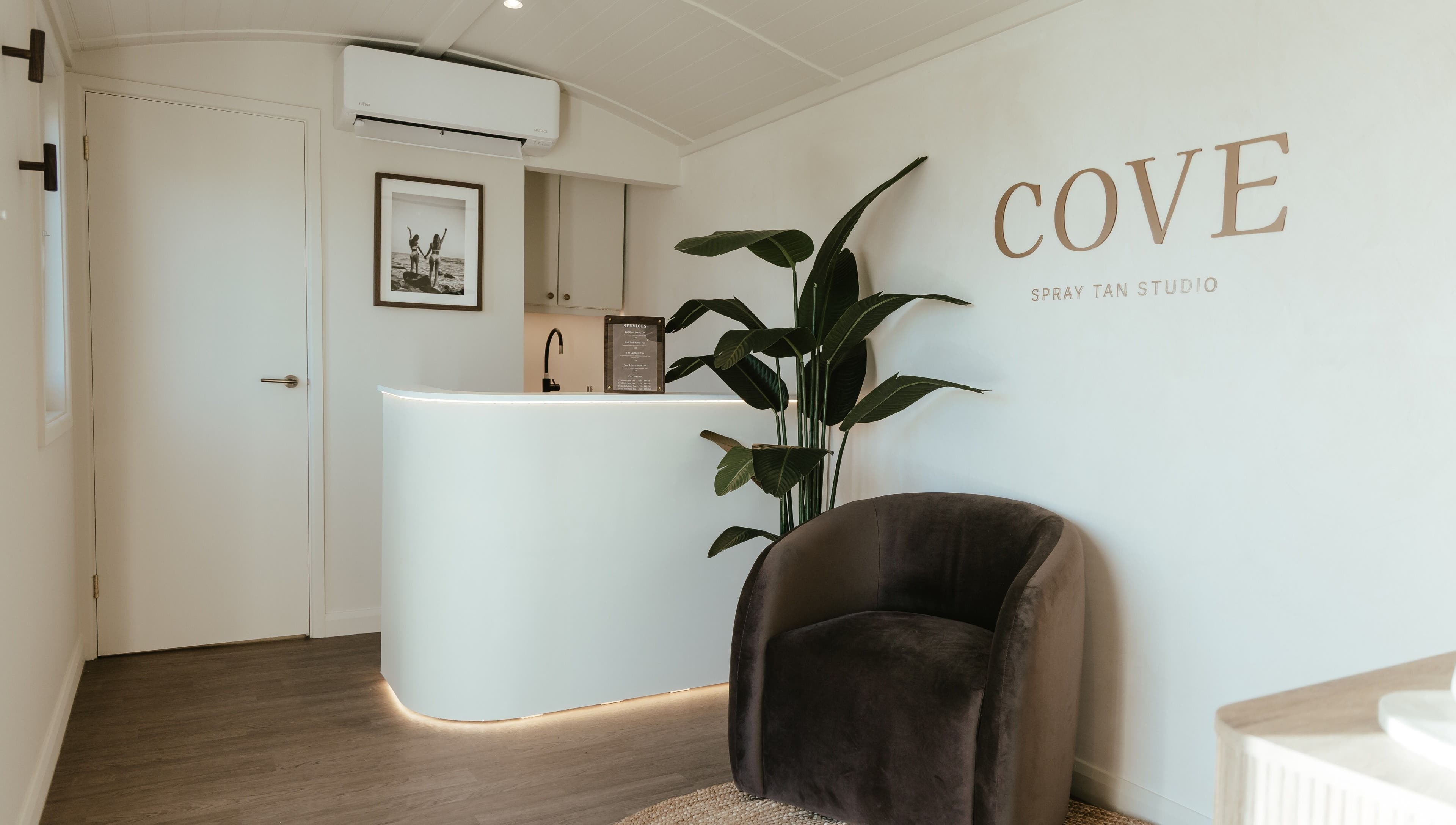 Elegant reception at COVE - Spray Tan Studio, Hethersett, England, GB with modern decor and lush plant.