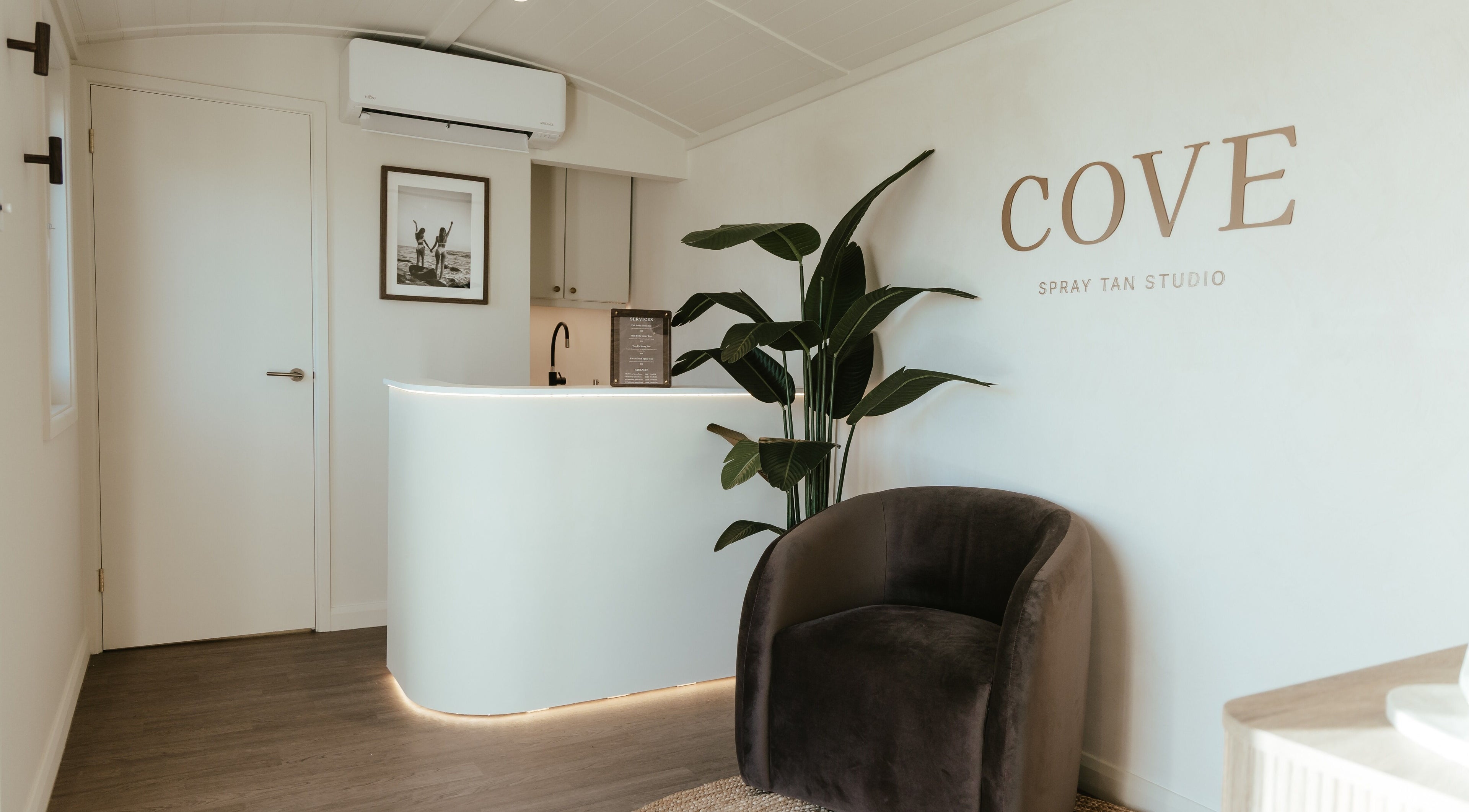 Elegant reception at COVE - Spray Tan Studio, Hethersett, England, GB with modern decor and lush plant.