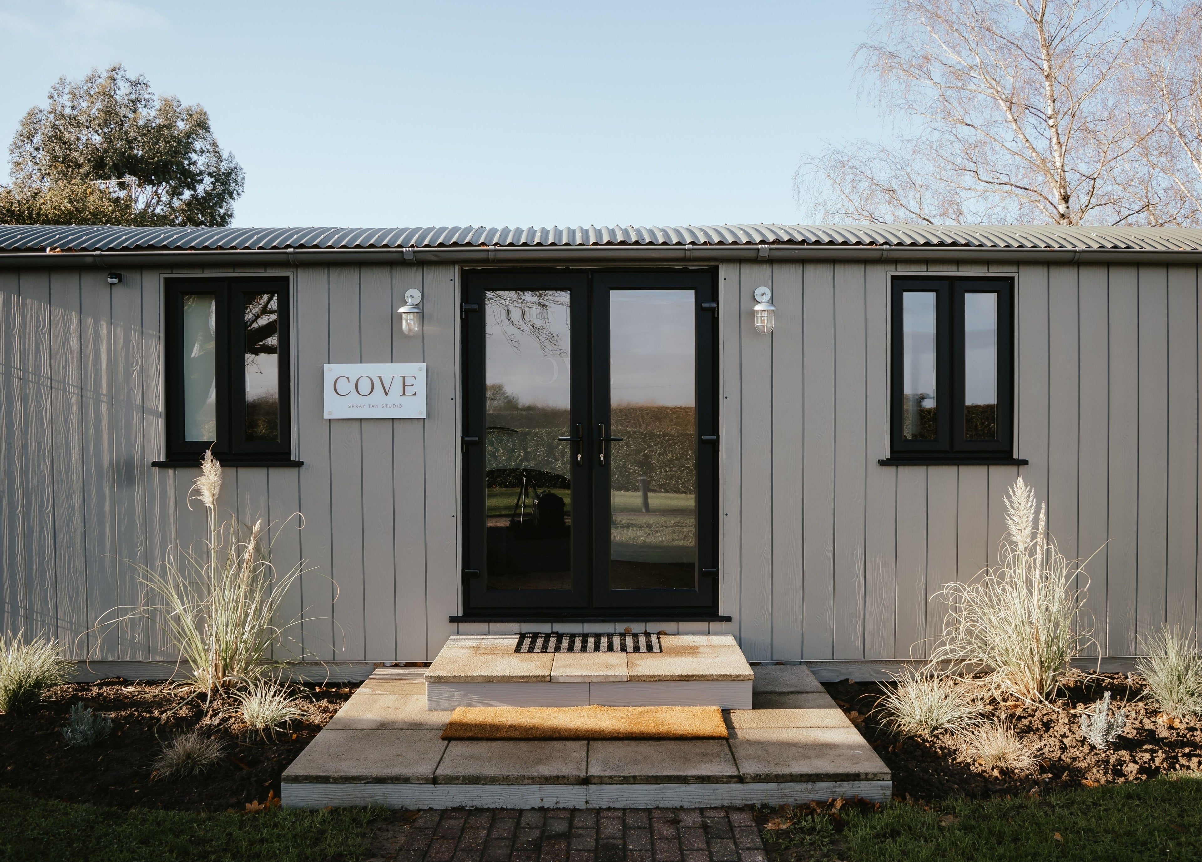 Entrance of COVE - Spray Tan Studio in Hethersett, England showcasing modern facade and welcoming design.